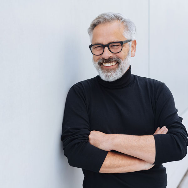 man smiling with his arms crossed