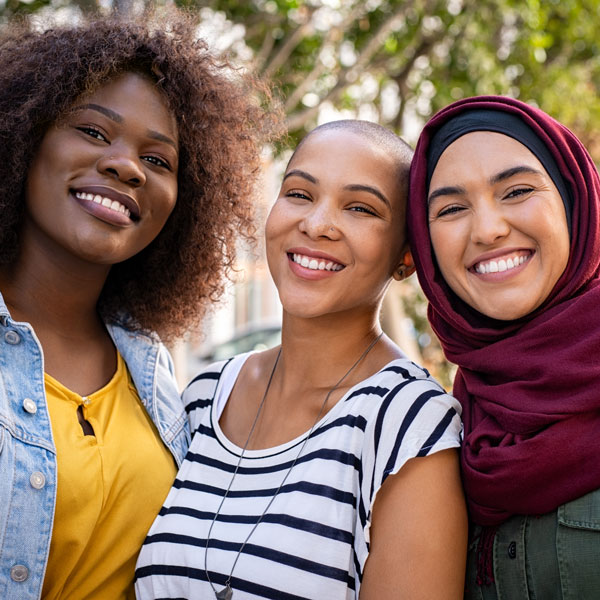 three friends smiling together