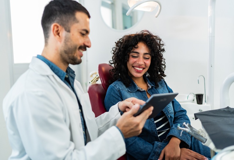 Dentist discussing dental restoration options, fillings, crowns, and implants in Fremont, IN