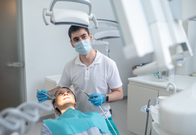 A dentist performing dental restoration treatment on a patient in Kenosha, WI